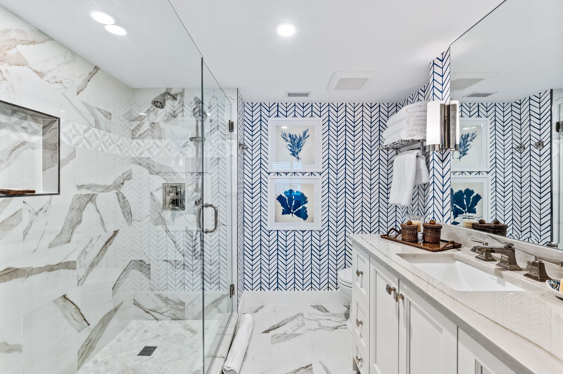 A bathroom with a walk in shower , sink , and mirror.