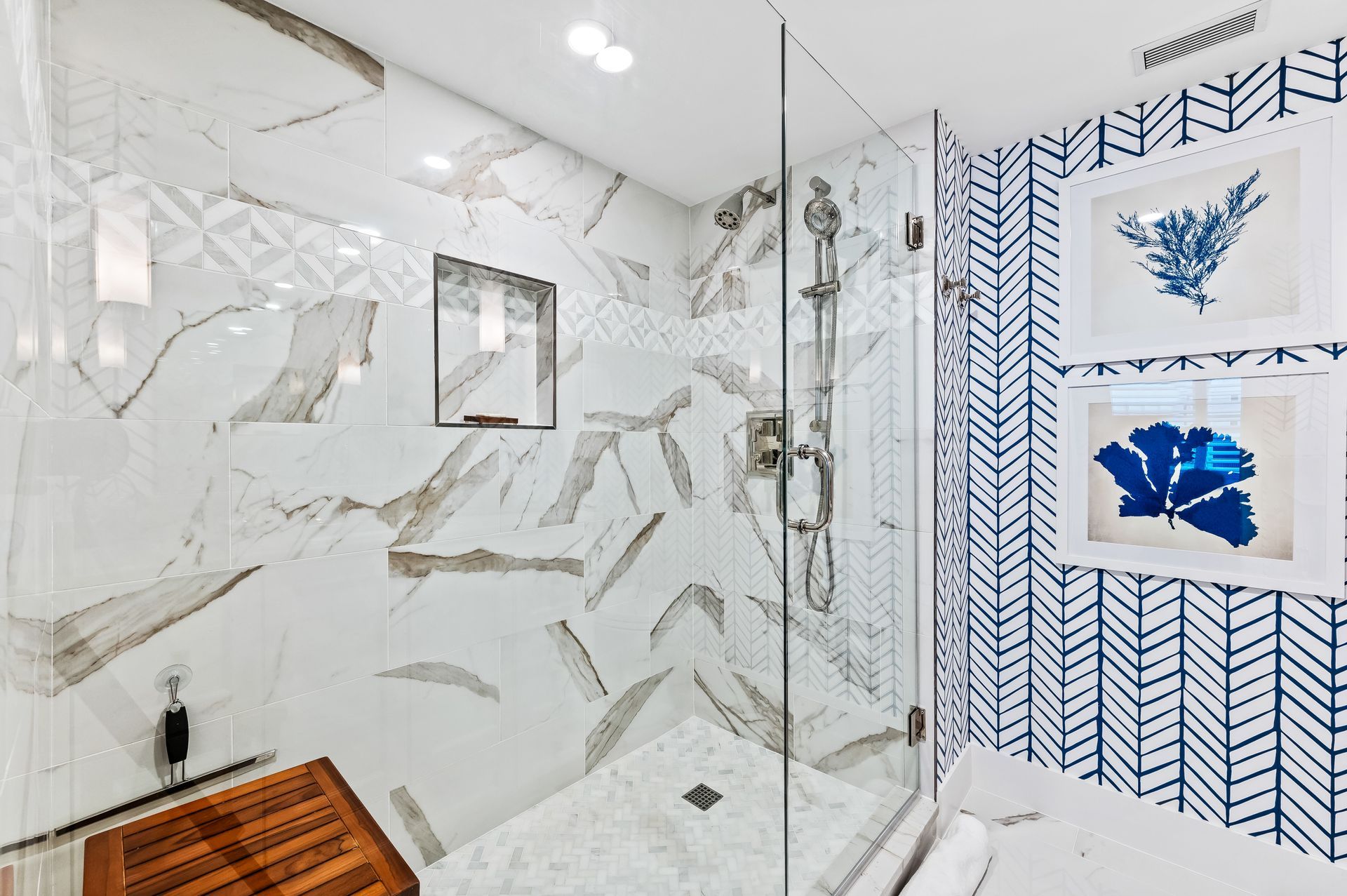 A bathroom with a walk in shower and a wooden floor.