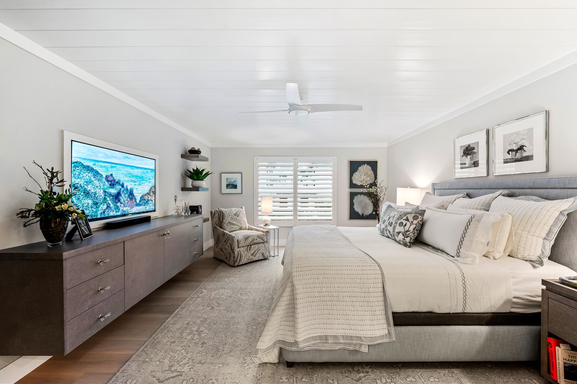 A bedroom with a large bed and a flat screen tv.