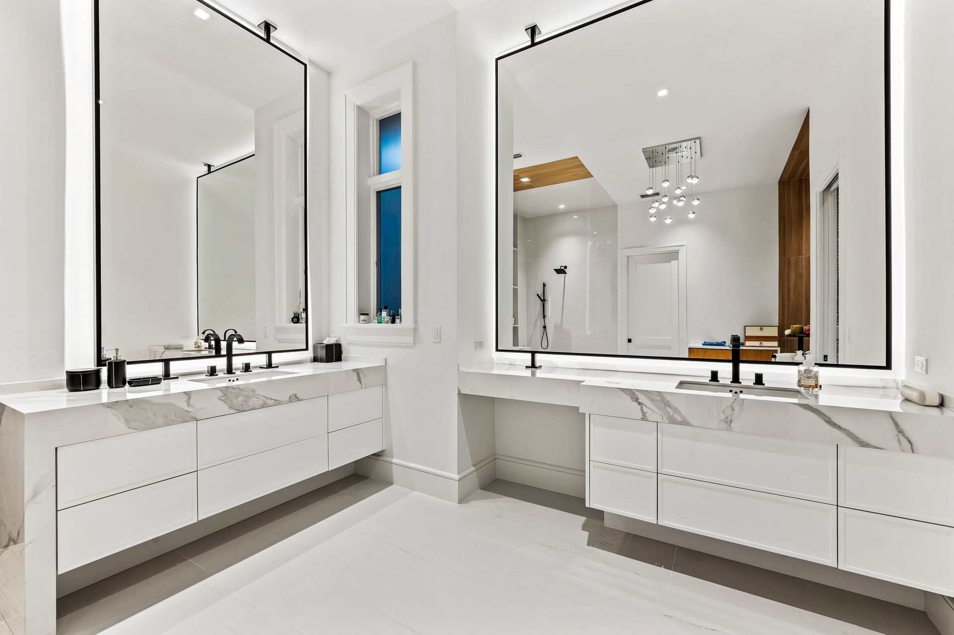 A bathroom with two sinks and two mirrors.