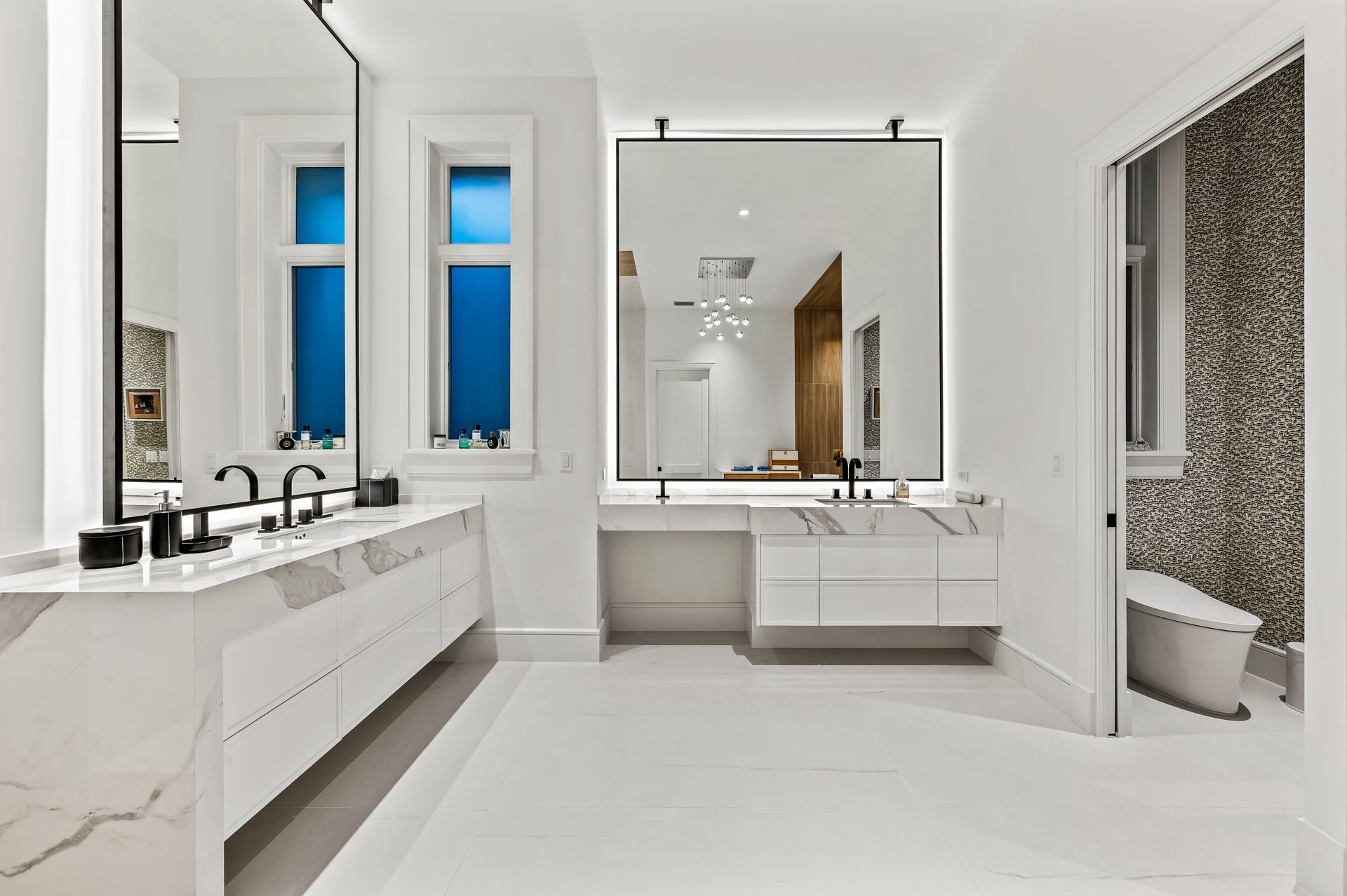 A bathroom with two sinks and a large mirror.