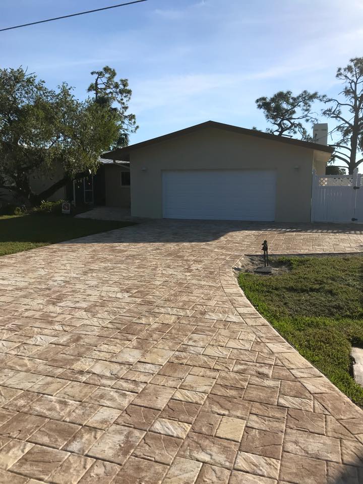 A driveway leading to a house with a garage.
