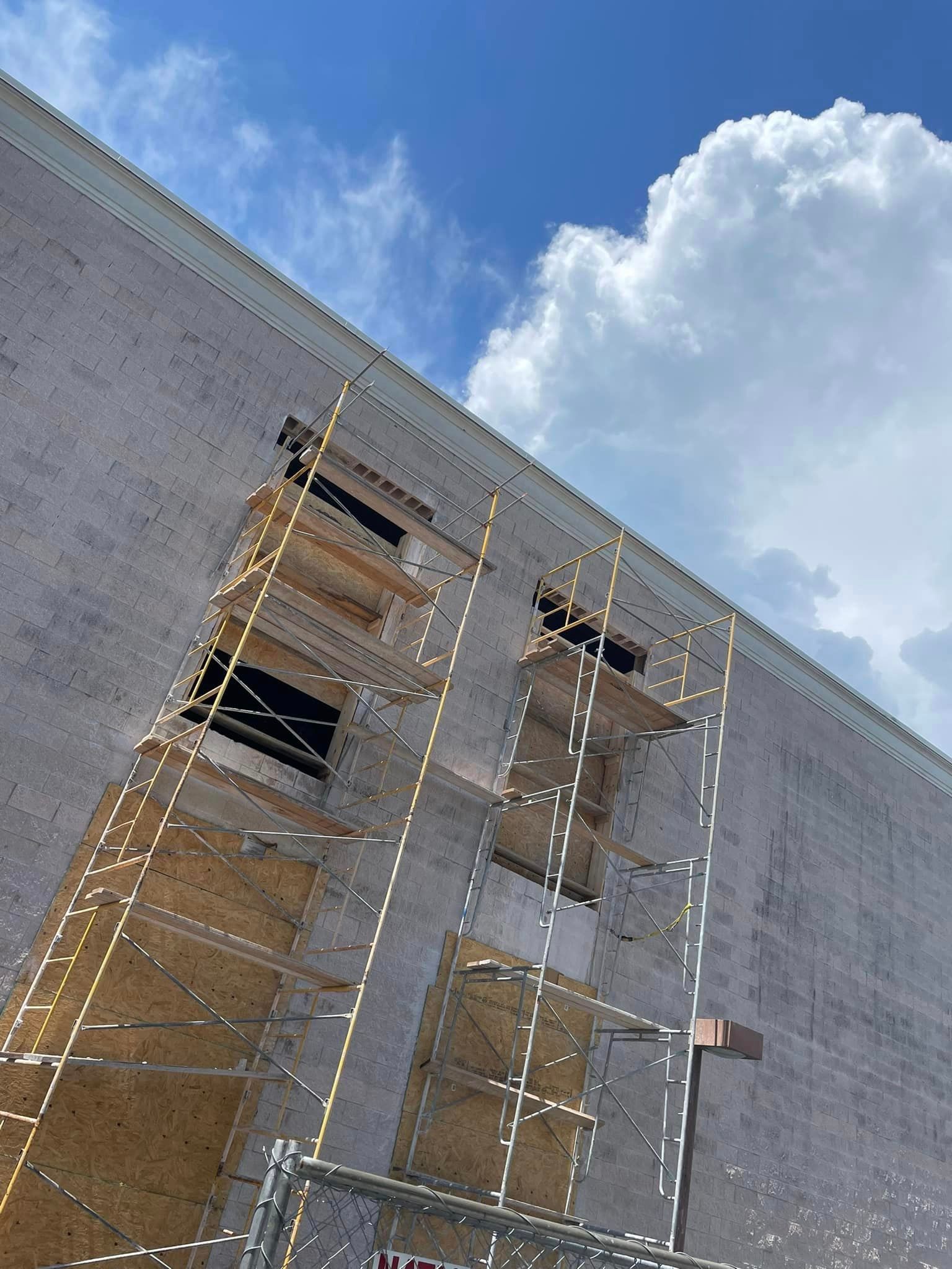A building under construction with scaffolding on the side of it.