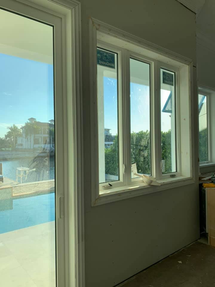 A room with a lot of windows and a sliding glass door.