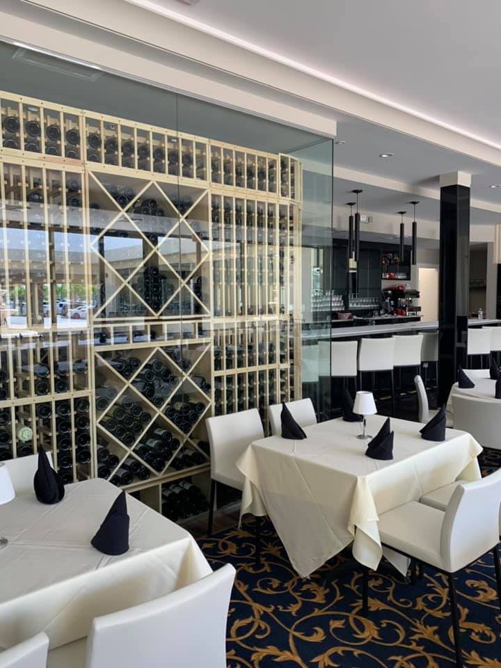 A restaurant with tables and chairs and a wine cellar