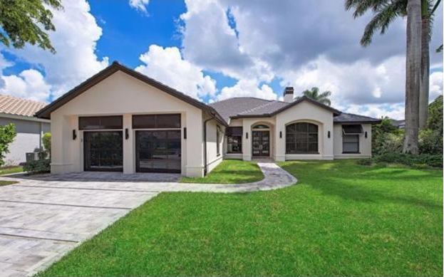 A large house with a lush green lawn in front of it.