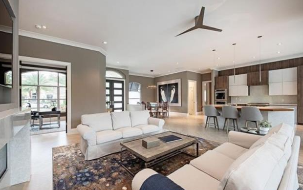 A living room filled with furniture and a ceiling fan.