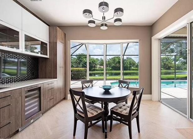 A dining room with a table and chairs and a chandelier.