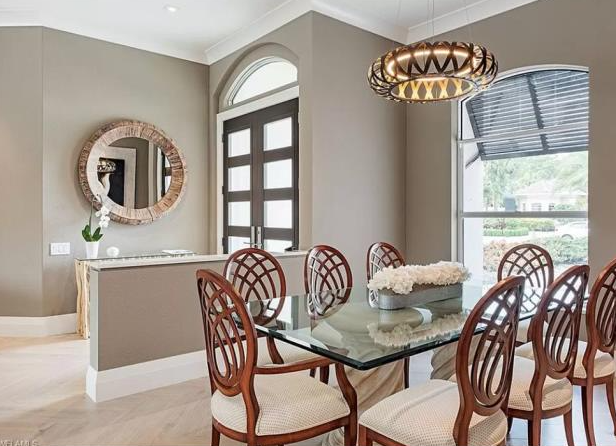 A dining room with a glass table and chairs