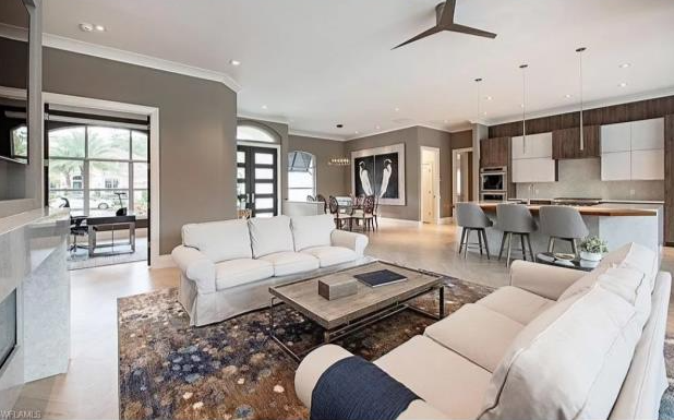 A living room filled with furniture and a ceiling fan.