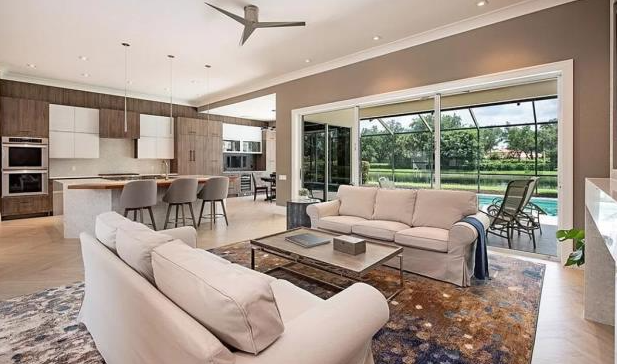 A living room filled with furniture and a ceiling fan.