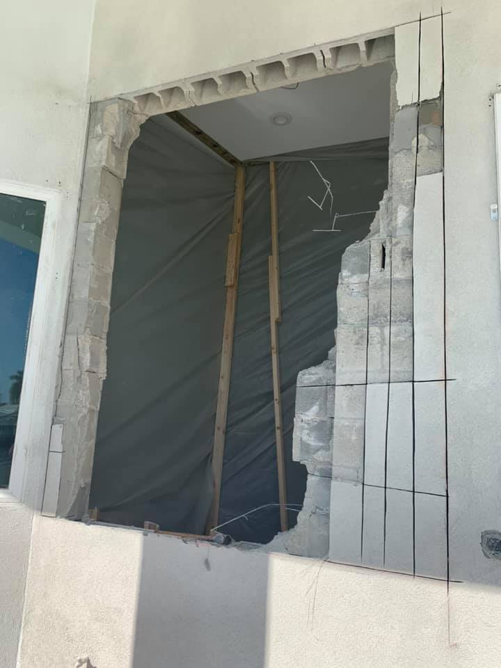 A room with a hole in the wall and a window