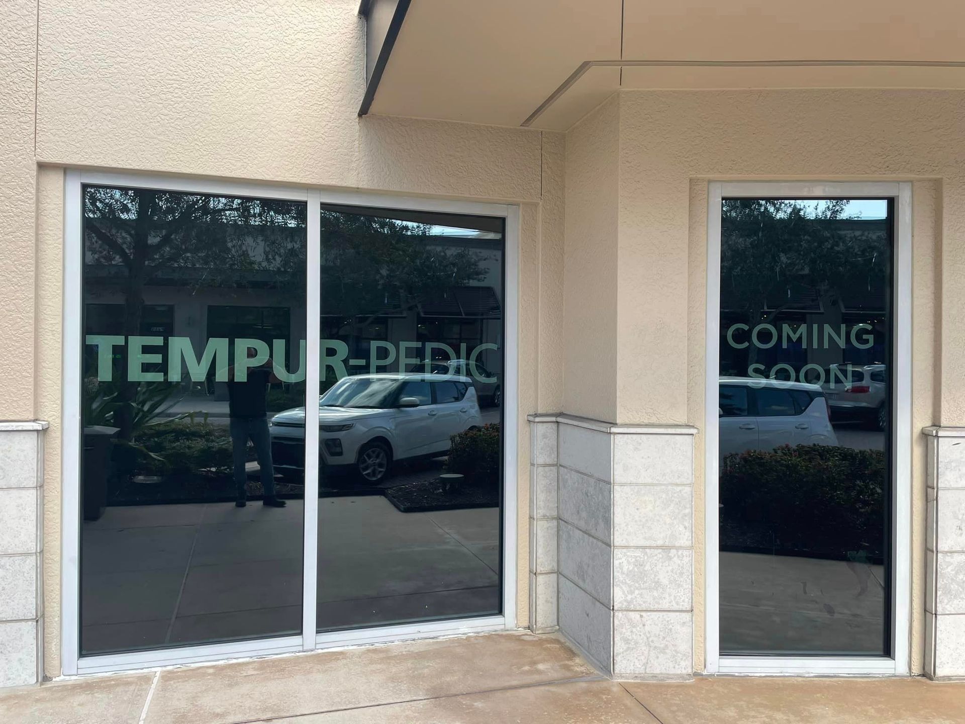 A building with a sign on the windows that says tempur pedic
