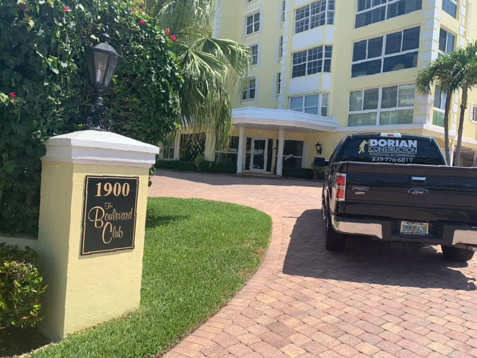 A black truck is parked in front of a building.