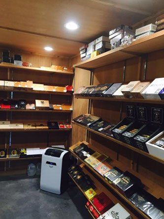 A room filled with shelves filled with boxes of cigars.