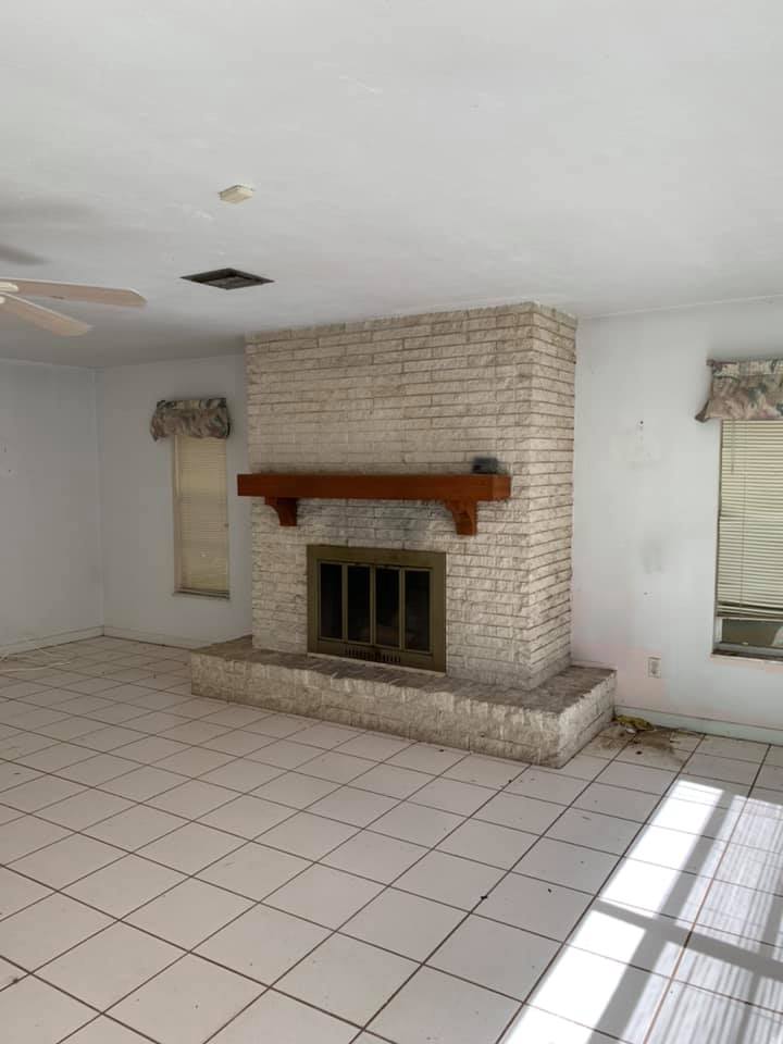 There is a fireplace in the middle of the living room.