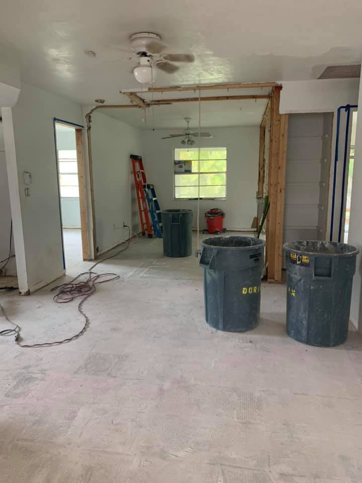 There are two trash cans in the middle of the room.