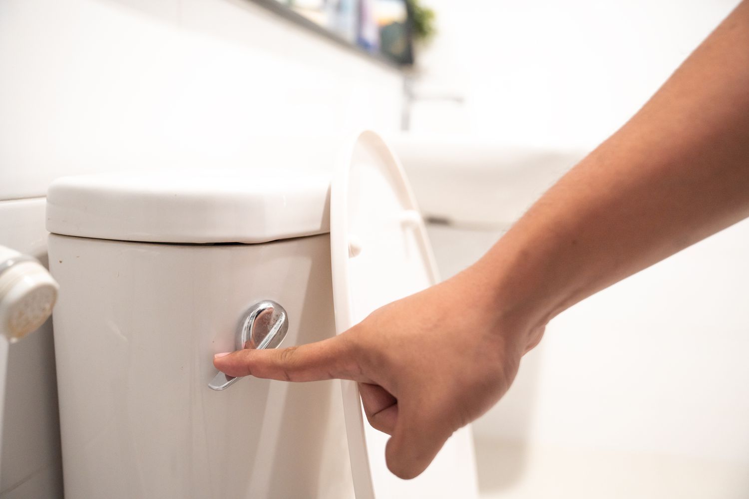 person flushing the toilet