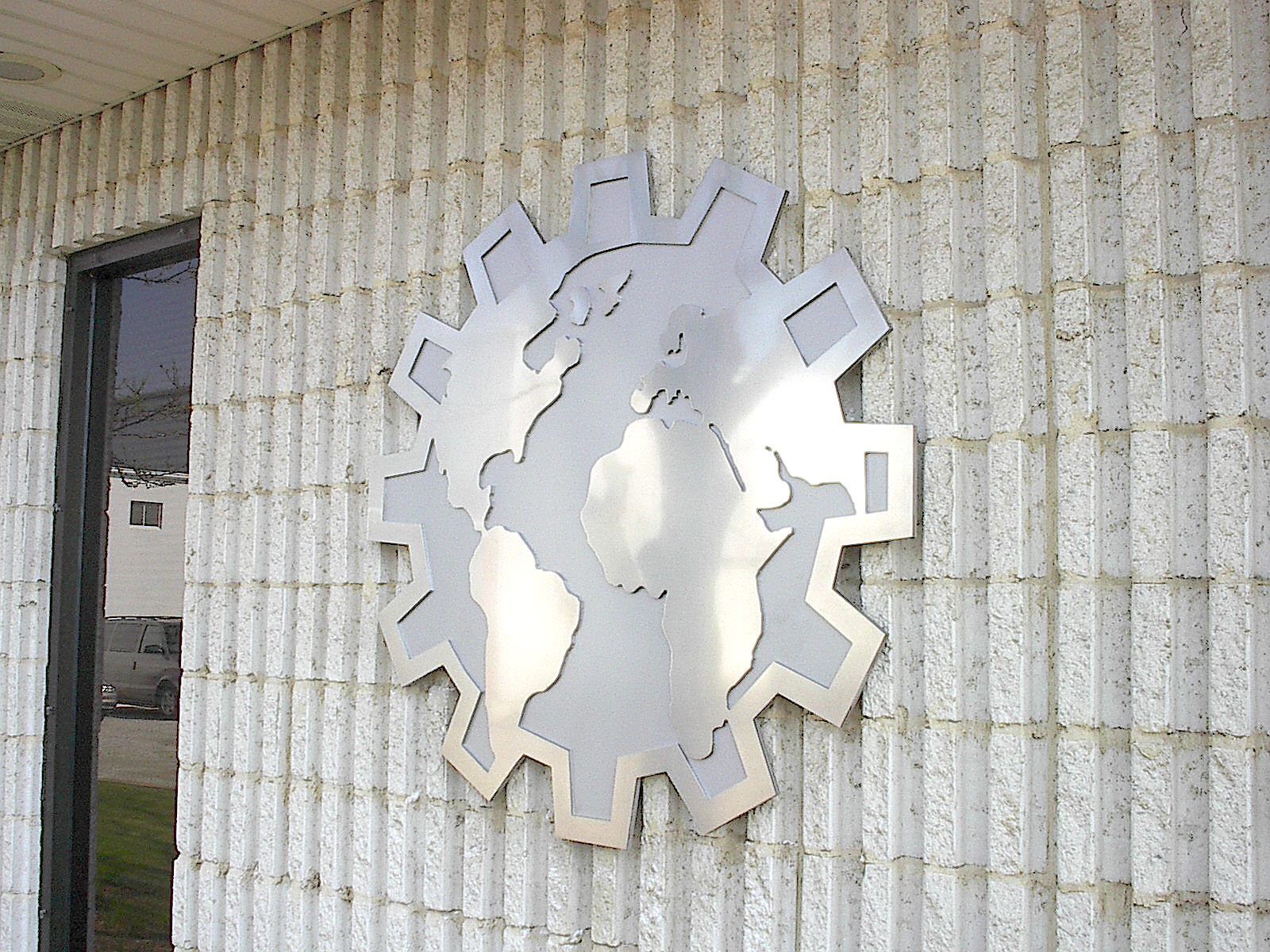 a sign on the side of a building that looks like a gear