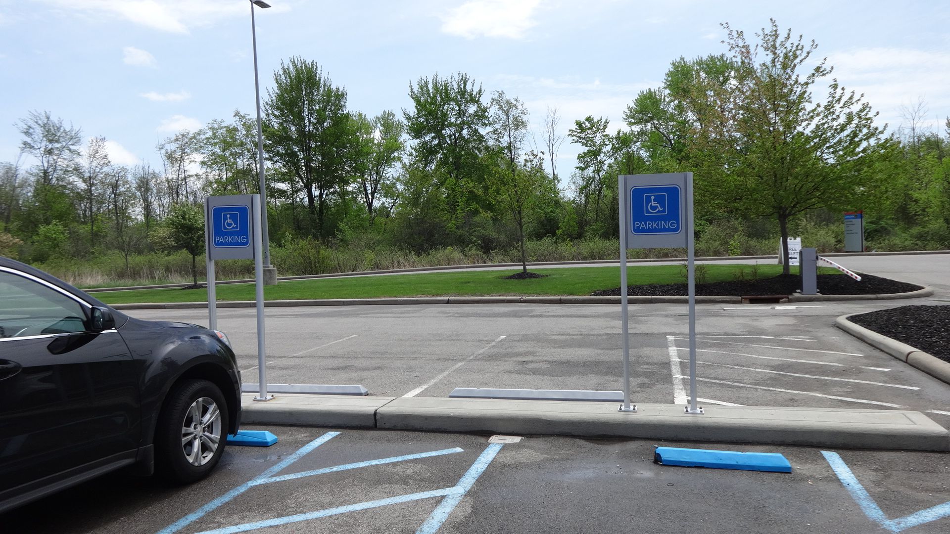 a black car is parked in a handicapped parking spot