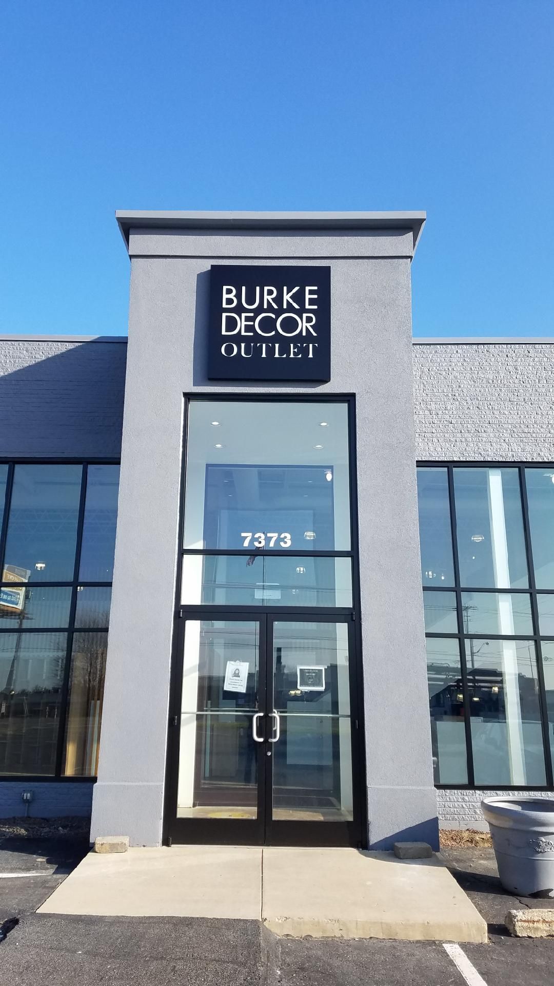 the front of a building with a sign that says burke decor outlet 