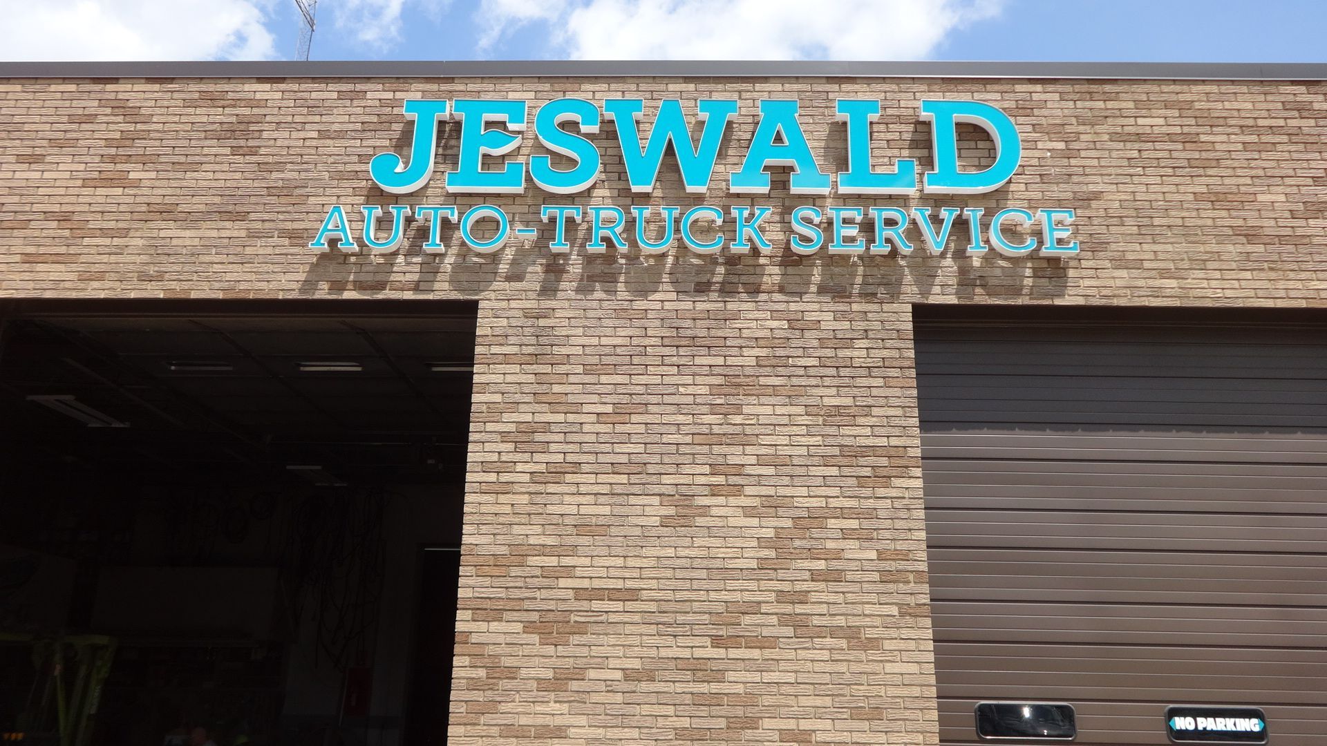 a brick building with a sign for jeswald auto truck service