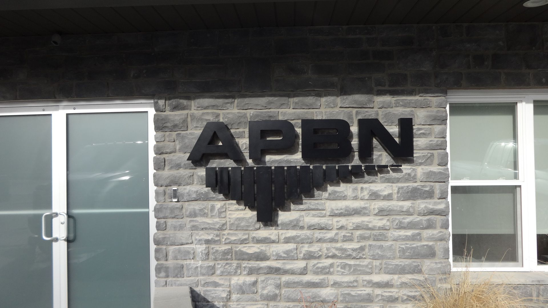 a brick building with a sign that says apbn on it