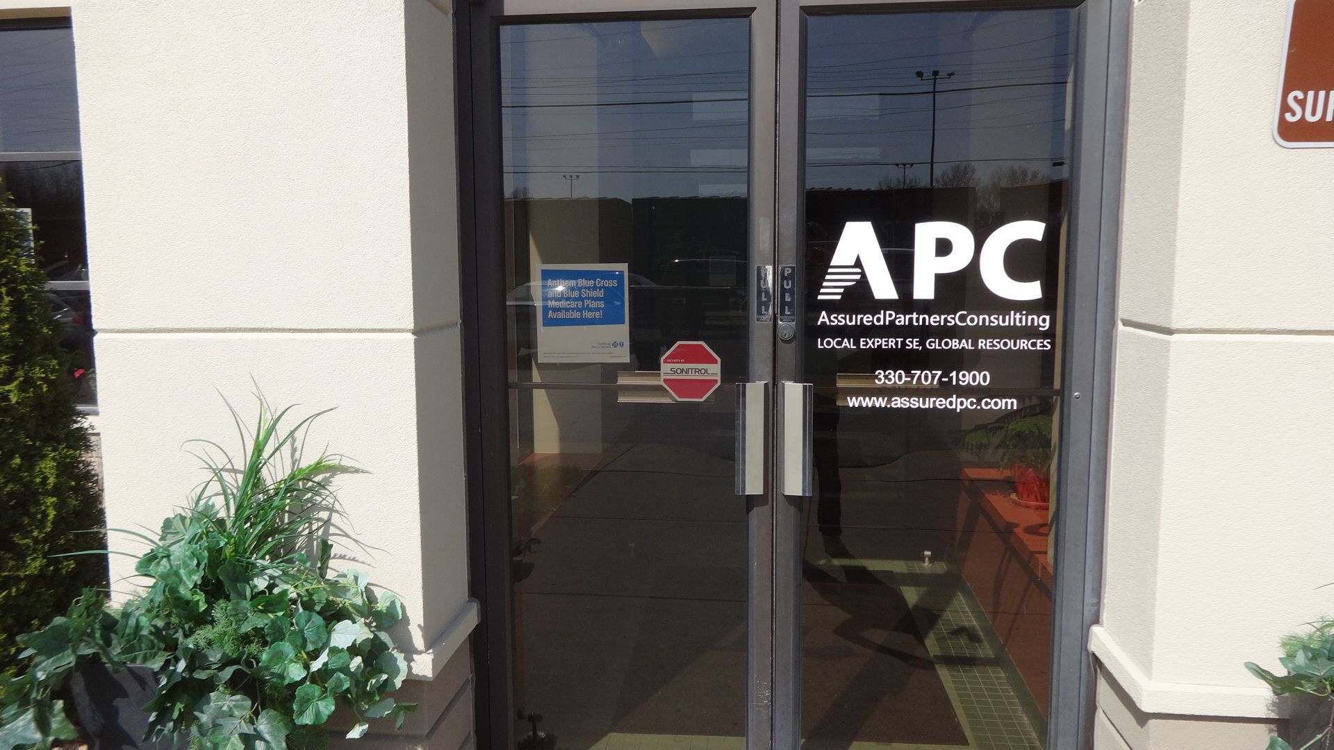 a glass door with the word apc on it