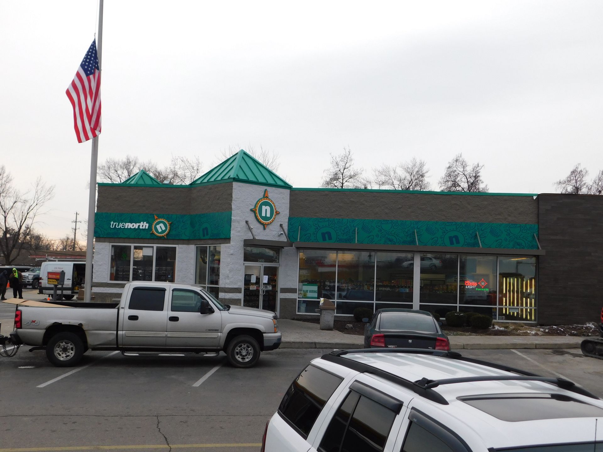 a silver truck is parked in front of a bank