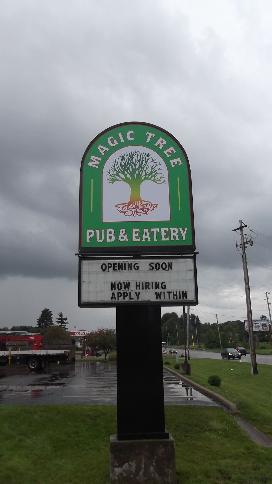 a sign for the magic tree pub and eatery