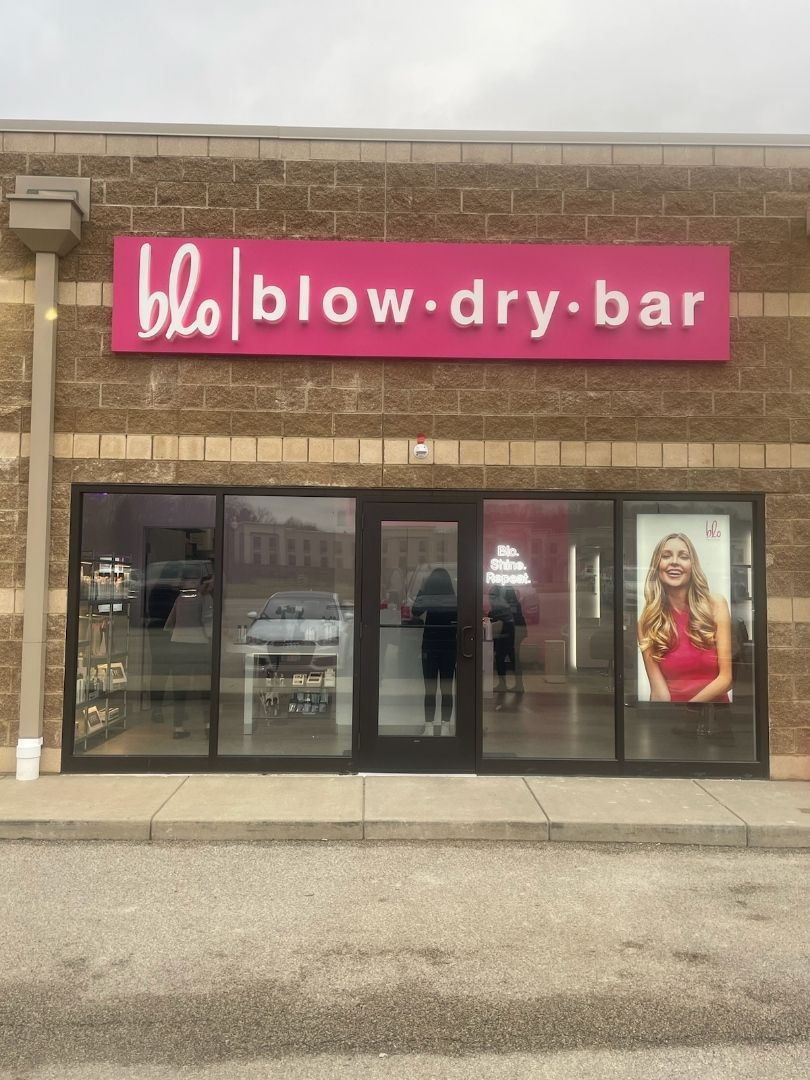 a blow dry bar is located in a brick building