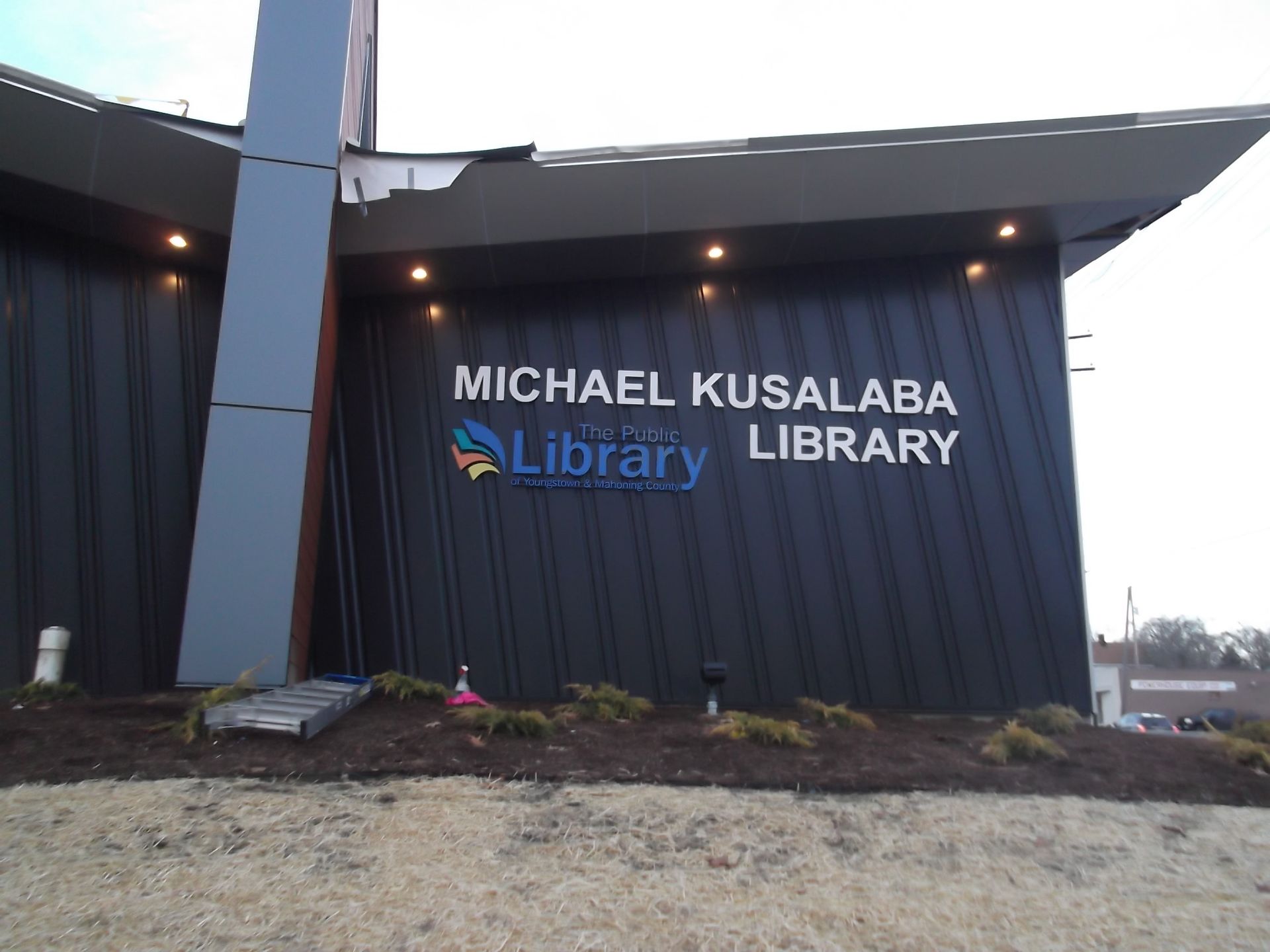 a black building with a sign that says michael kusalaba library