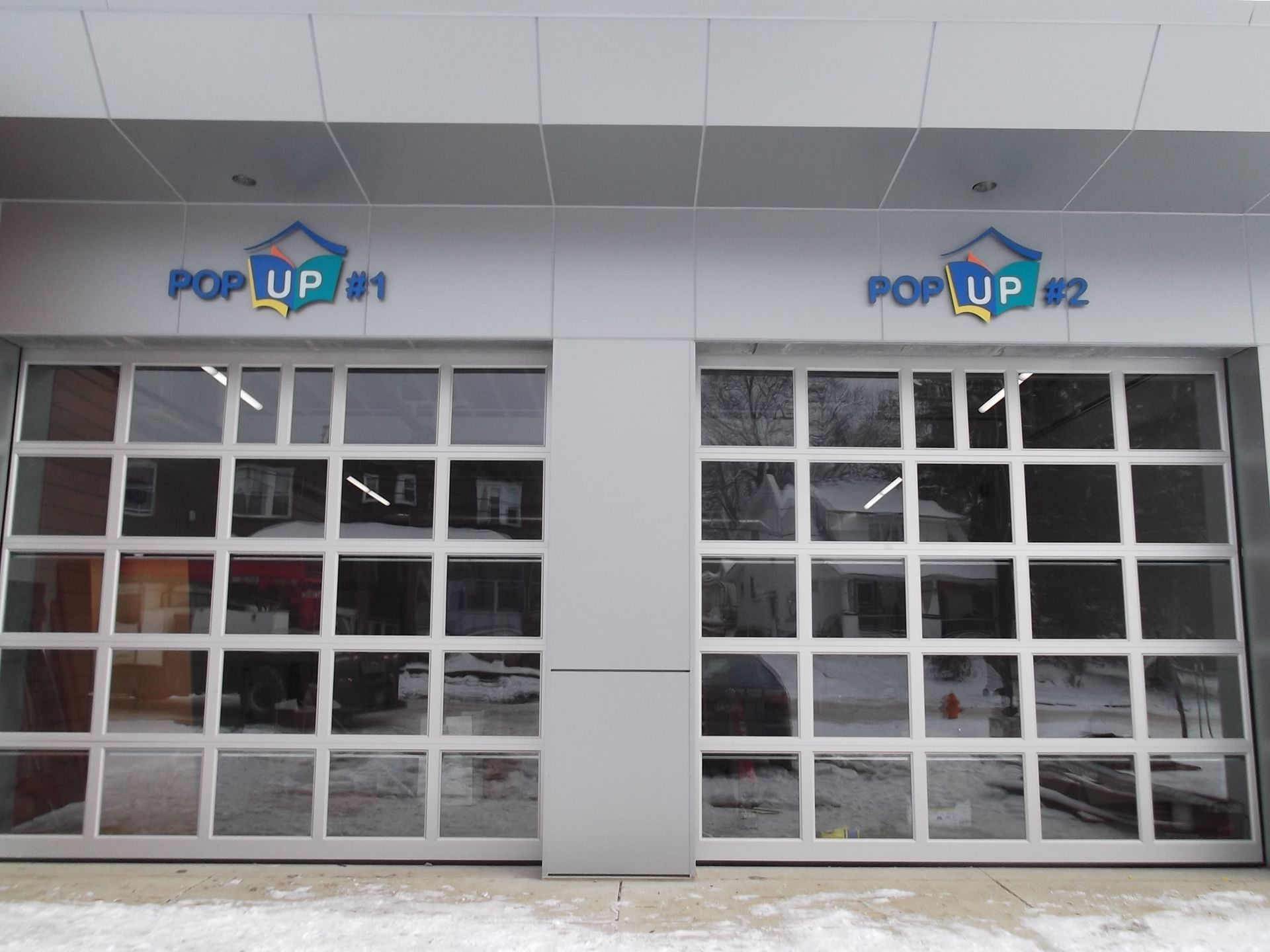 a building with a sign that says pop up # 1 and pop up # 2