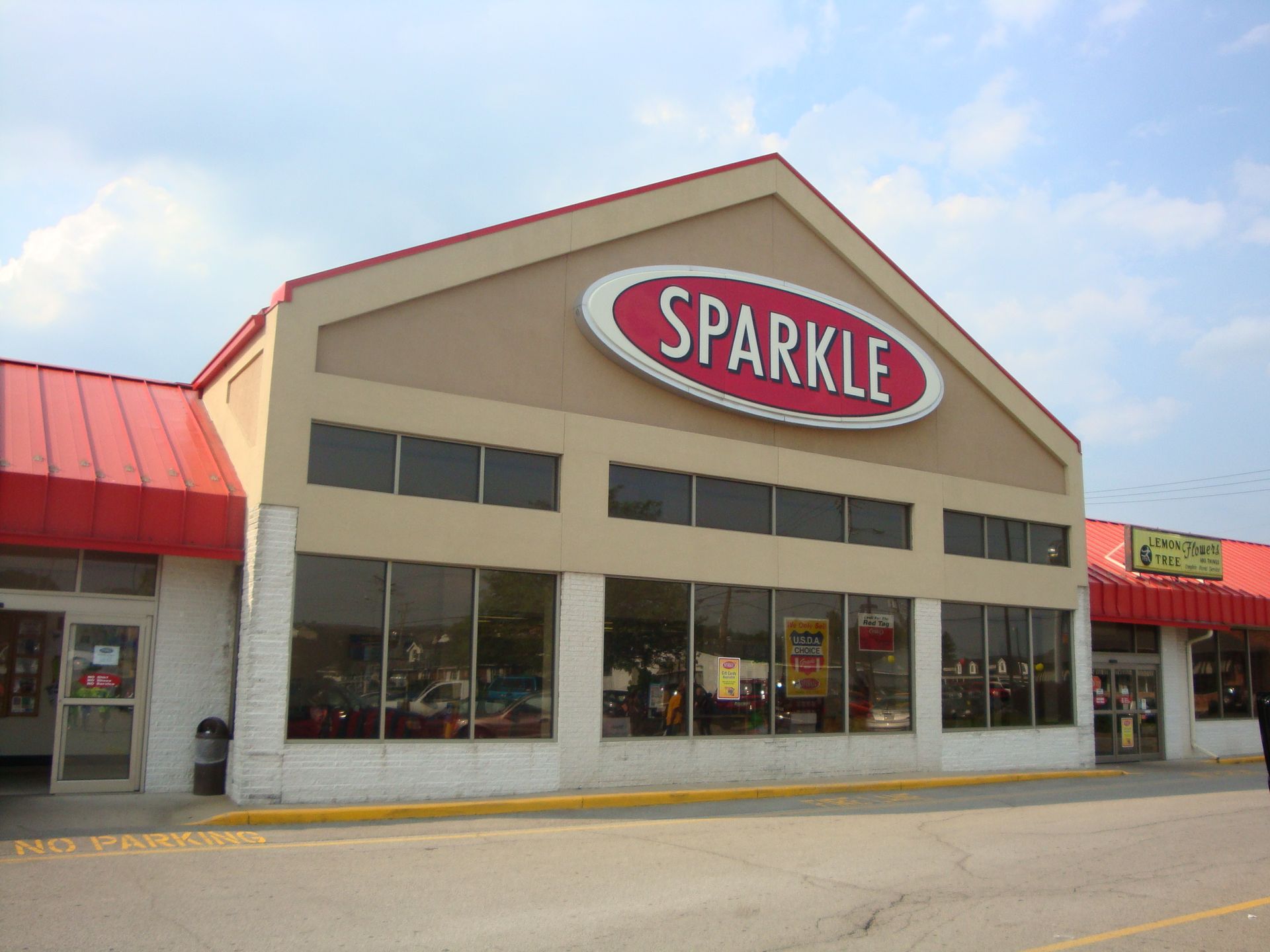 the front of a sparkle store with a red awning