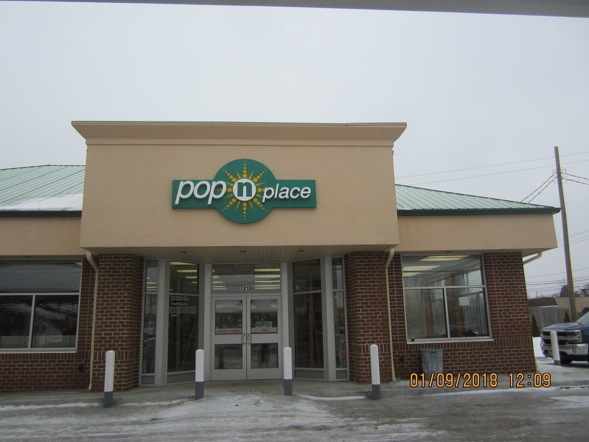 the front of a pop u place store in the snow