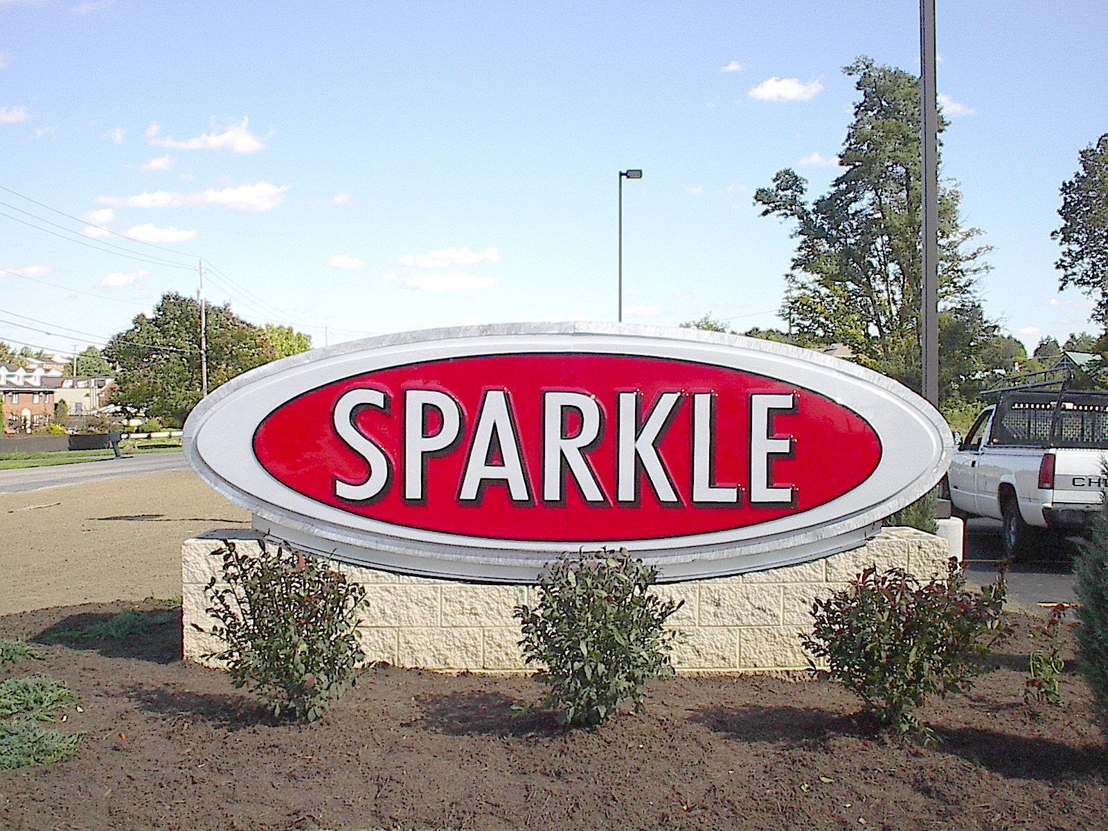 a red and white sign that says sparkle on it