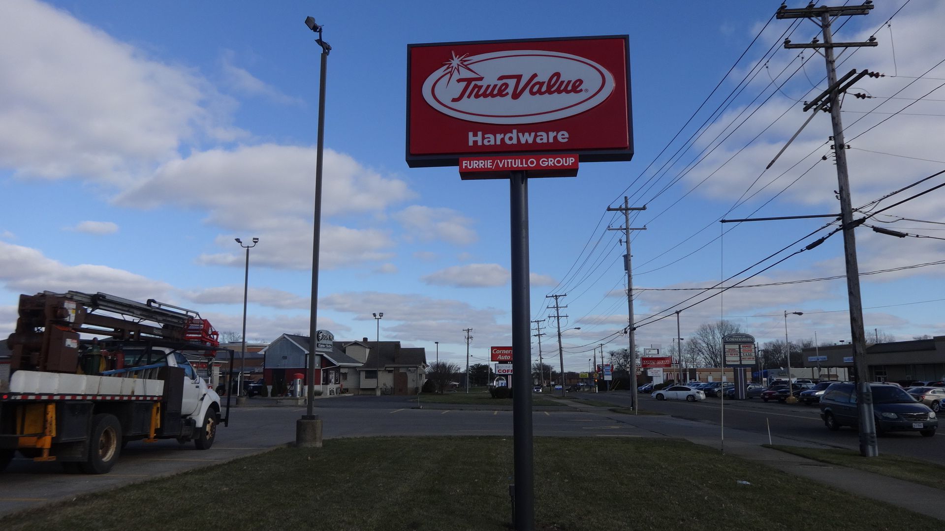 a truck is parked in front of a true value hardware sign