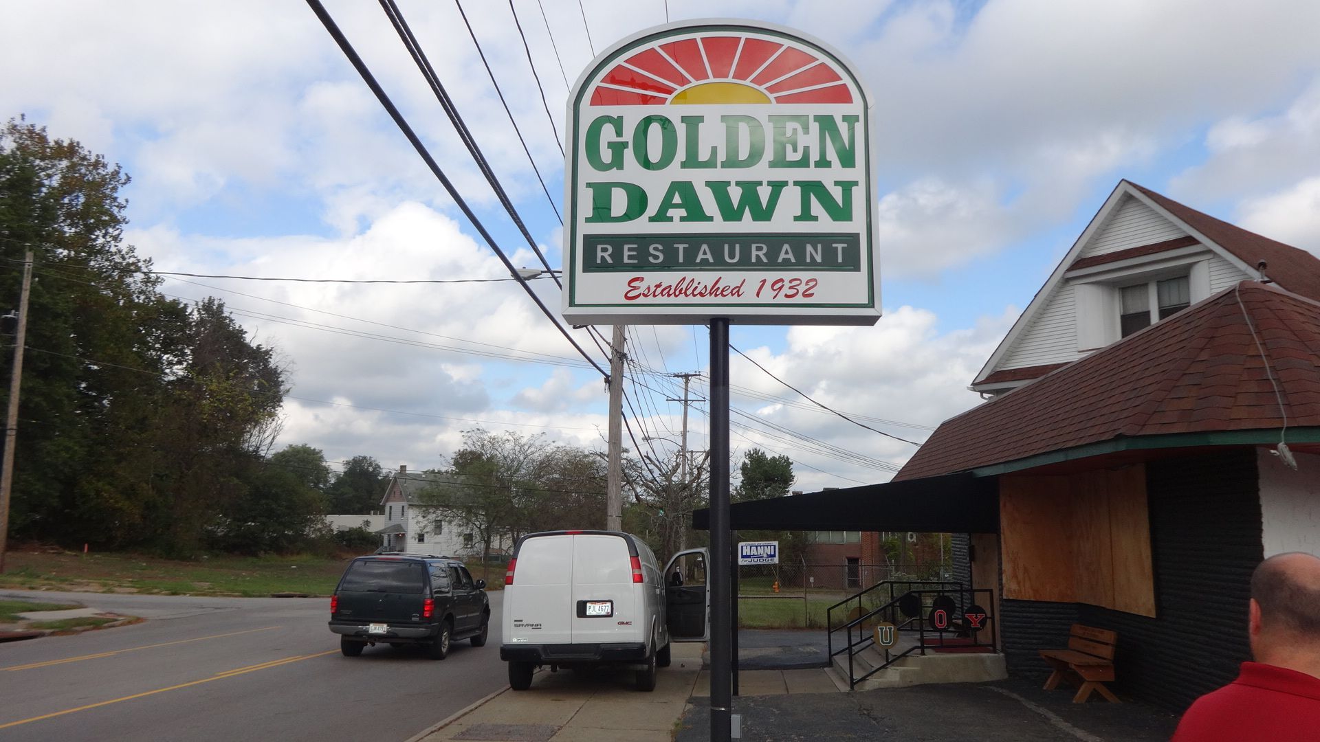 a sign that says golden dawn restaurant on it