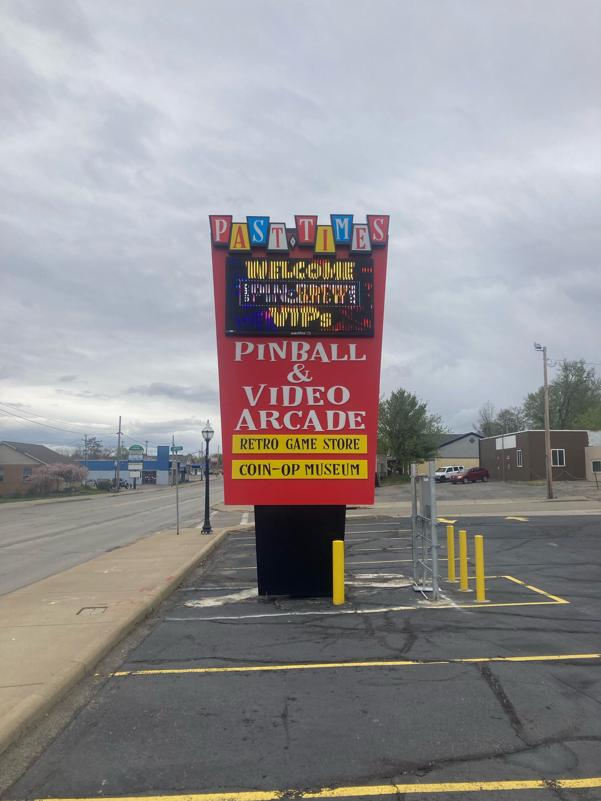 a sign for a pinball and video arcade in a parking lot