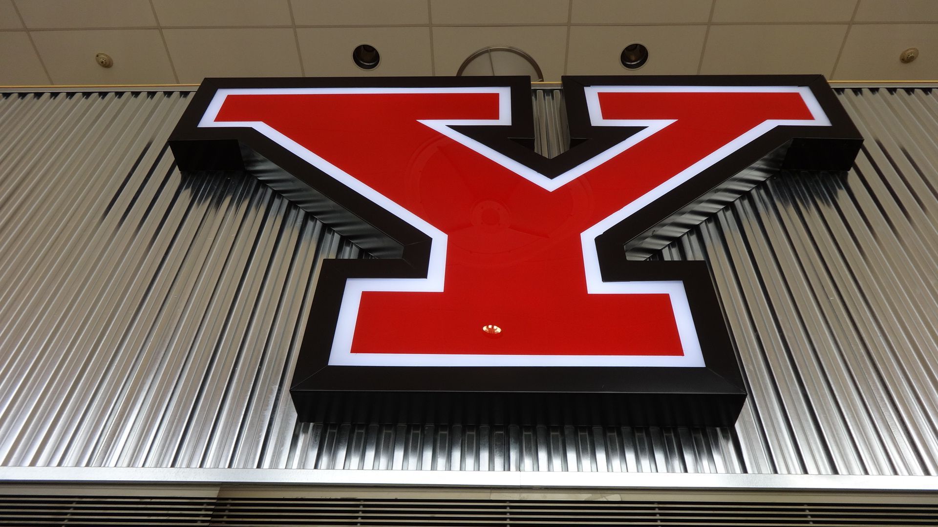 a large red and black letter y on a metal wall
