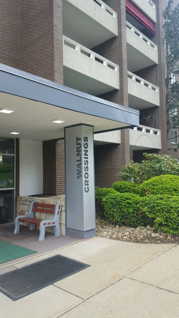 a building with a sign that says walnut crossings on it