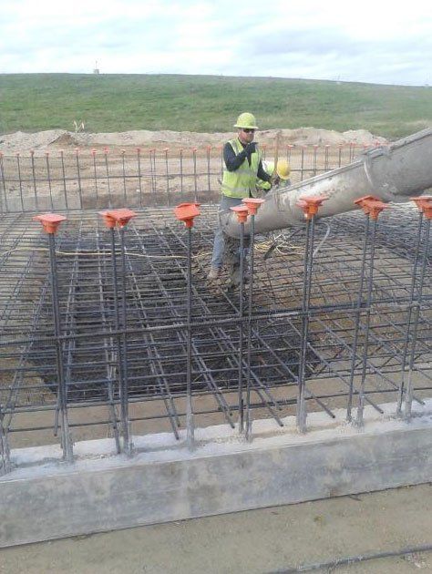 man working on concrete foundation