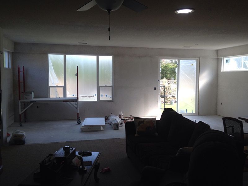 A living room with a couch a table and a ceiling fan