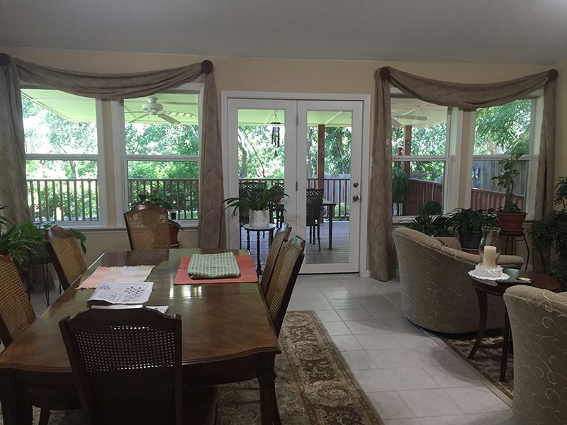 A living room with a dining table and chairs