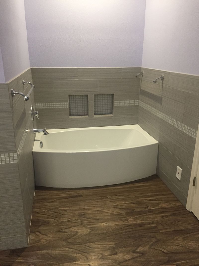 There is a bathtub in the middle of the bathroom.