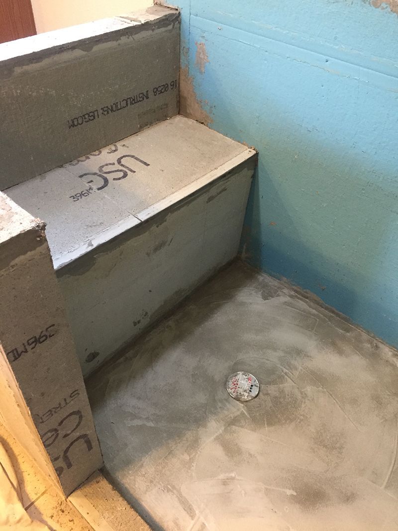 A shower stall is being built in a bathroom.