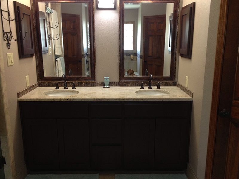 A bathroom with two sinks and two mirrors.
