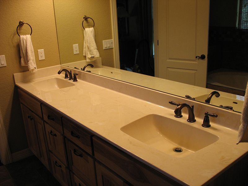 A bathroom with two sinks and a large mirror