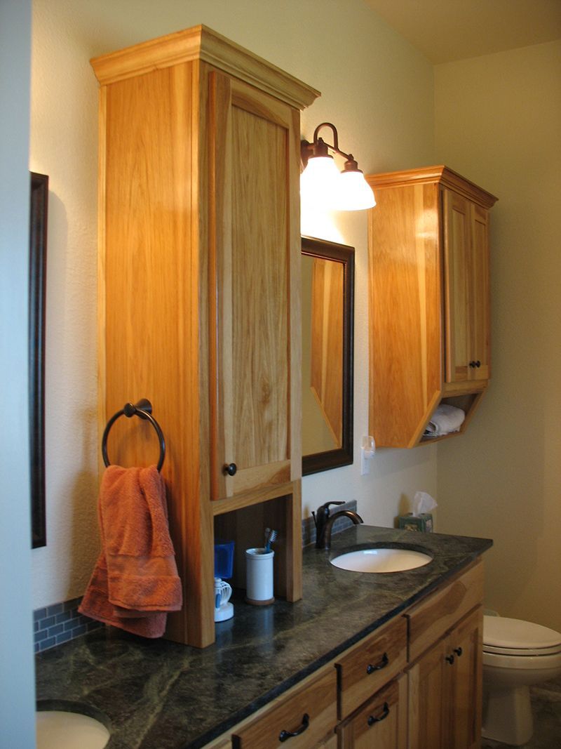 A bathroom with two sinks and a toilet