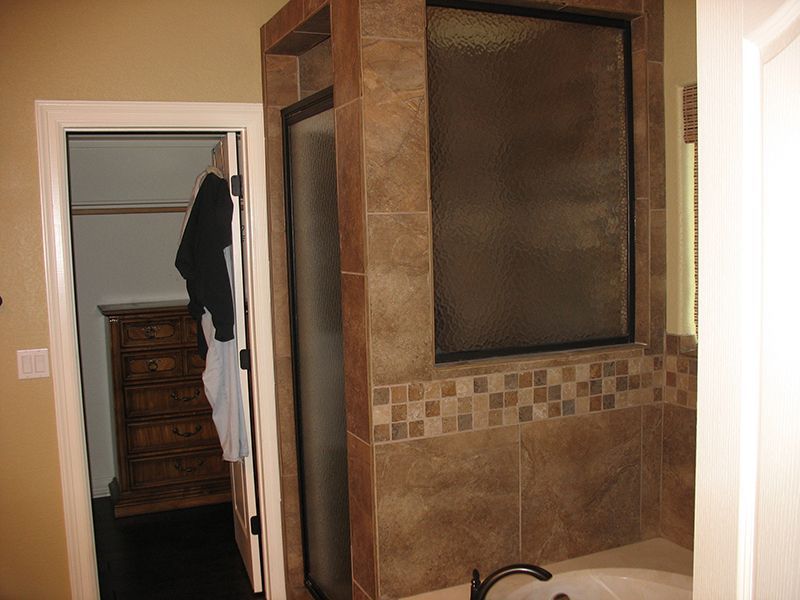 A bathroom with a tub and a walk in shower